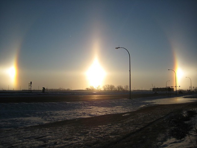 6. Sun dogs: This is a phenomenon that his actually another massive light refraction because of crystals in the atmosphere. Sun dogs appear to circle the sun and appear as two distinctive bright spots on either side of the halo. This phenomena can even make it look like there are three suns in the sky.